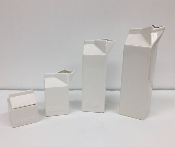 Set of four white ceramic pop art design collectibles
