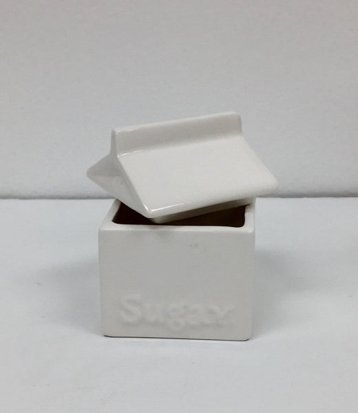 Set of four white ceramic pop art design collectibles