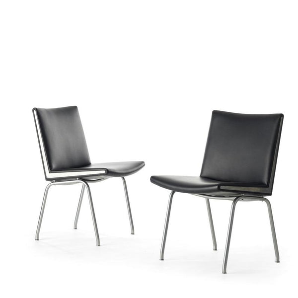 Set of two black vinyl and steel Kastrup chairs by Hans Wegner made by A.P. Stolen